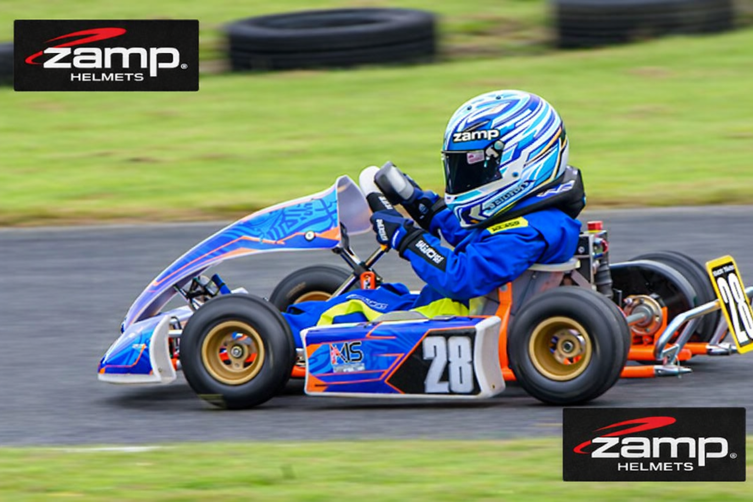 Person driving a go-kart on a track with Zamp Helmets branding.